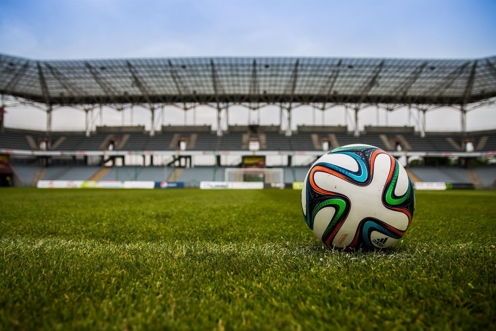 Football on grass in empty an stadium